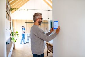 man,using,smart,home,control,panel.